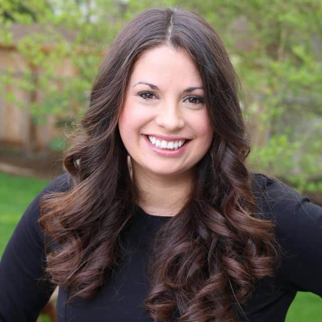 A young woman with long brown hair smiling. Sarah Olson of The Magical Slow Cooker.