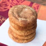 A stack of Pumpkin Spice Snickerdoodles on a square of parchment paper.