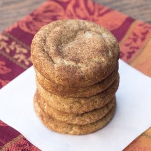A stack of pumpkin spice snickerdoodles on a white plate.