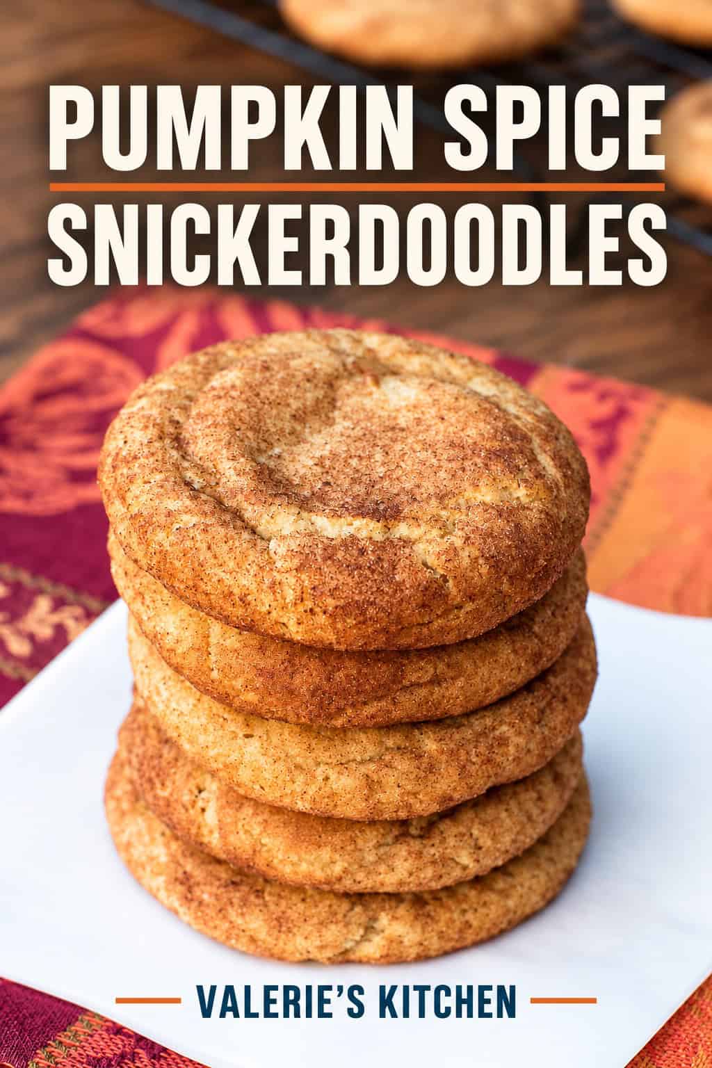 Soft pumpkin spice snickerdoodle cookies coated in spiced sugar, arranged on a plate.