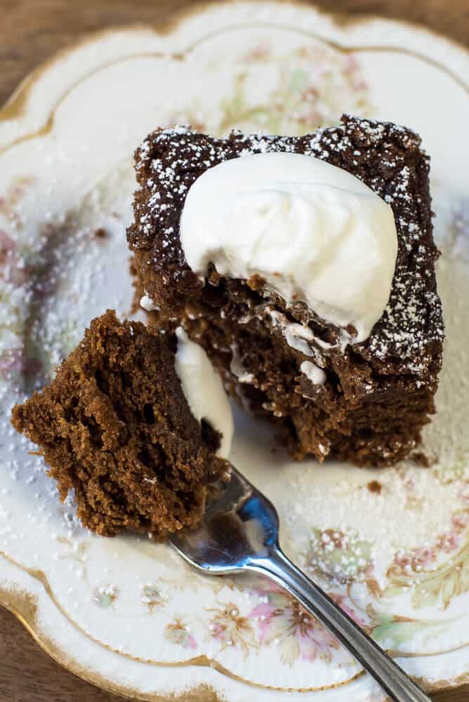 A closeup image of Mom's Old-Fashioned Gingerbread on a pretty china plate with a fork.