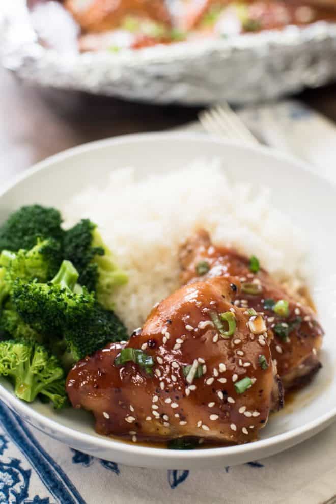 Baked Chicken Teriyaki in a white serving bowl with white rice and broccoli.