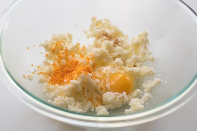 Butter, sugar, egg, vanilla, and orange zest in a mixing bowl.