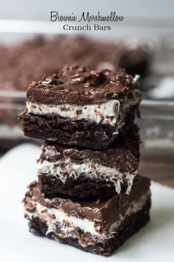Brownie Marshmallow Crunch Bars stacked on a plate.