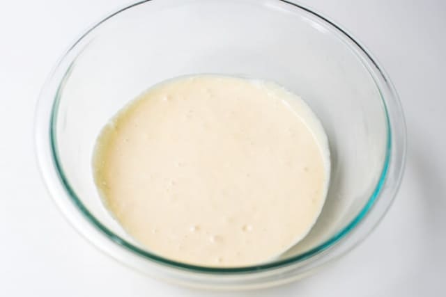 A smooth batter mixture in a glass mixing bowl.