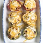 Colorful bell peppers stuffed with a meat filling and topped with melted cheese.