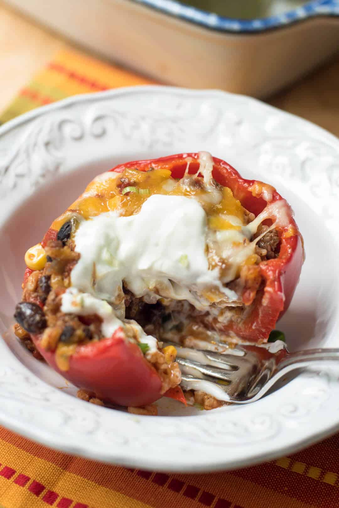 A closeup of a fork breaking into a Mexican Stuffed Bell Pepper.