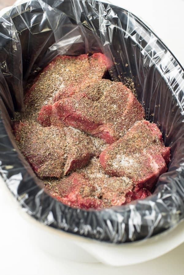 Seasoned beef in a slow cooker.