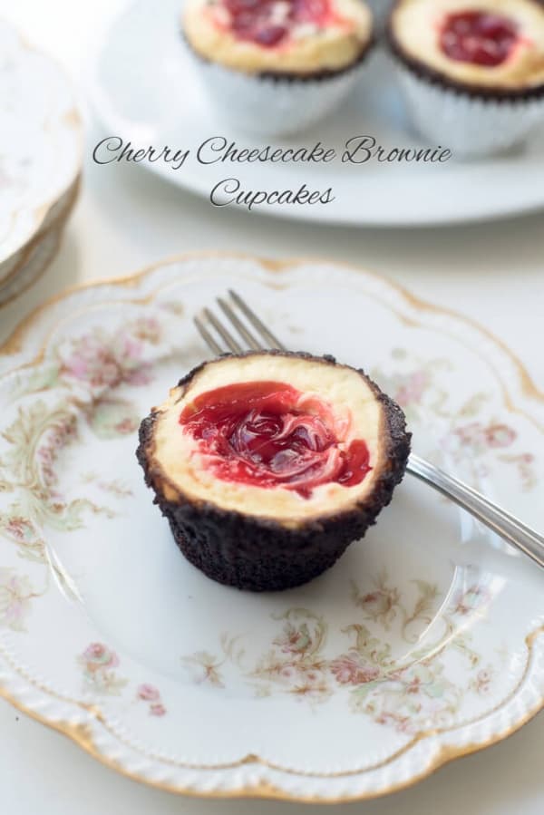 A Cherry Cheesecake Brownie Cupcake on a pretty china plate with a fork.