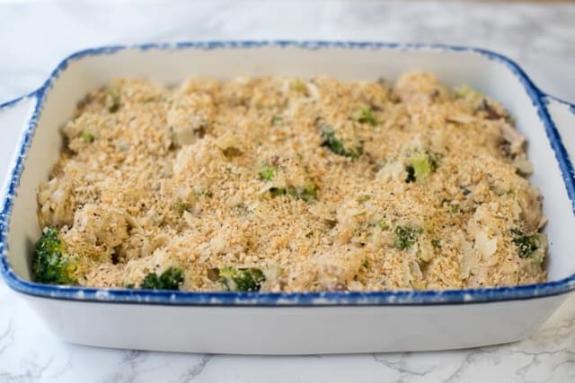 Creamy Chicken Broccoli and Rice Casserole topped with breadcrumbs in a blue and white baking dish.