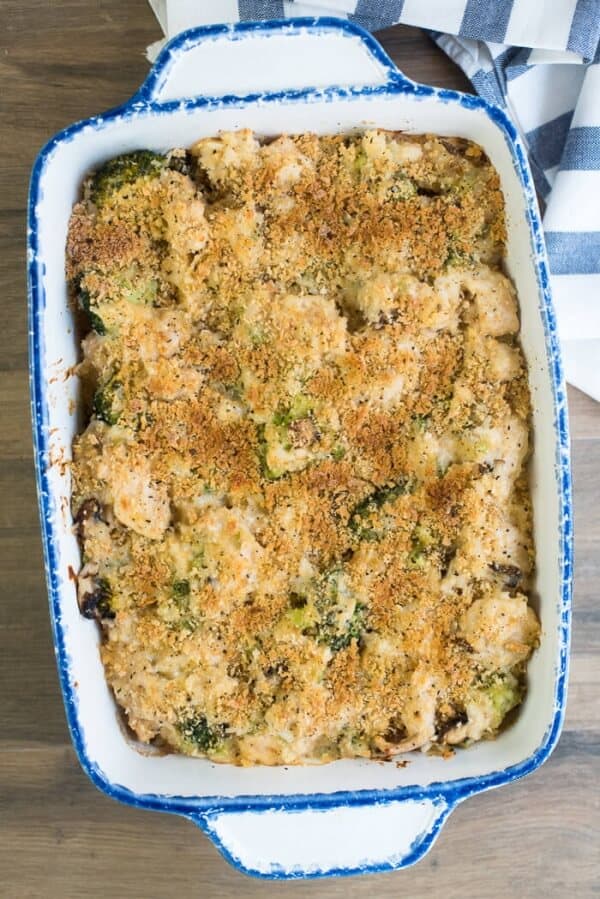 A baking dish filled with chicken broccoli and rice casserole topped with bread crumbs.