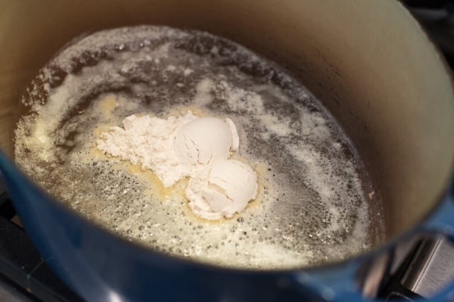 Melted butter and flour in a Dutch oven on the stove.
