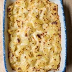 A baking dish fill with au gratin potatoes.