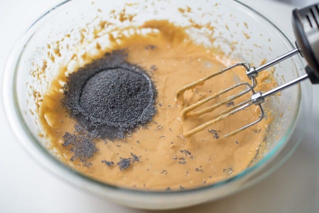 Poppy seeds and warm water are added to the cake batter.