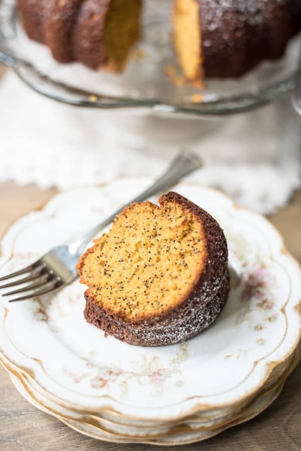 A slice of Butterscotch Poppy Seed Bundt Cake on a pretty china plate.