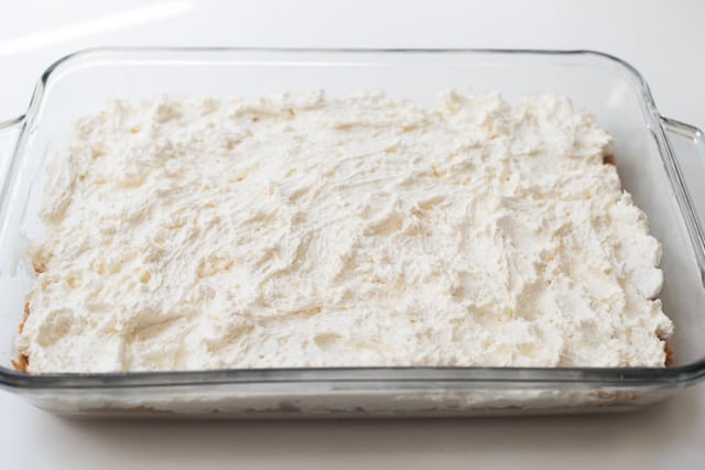 A cream cheese mixture spread out over a crust.