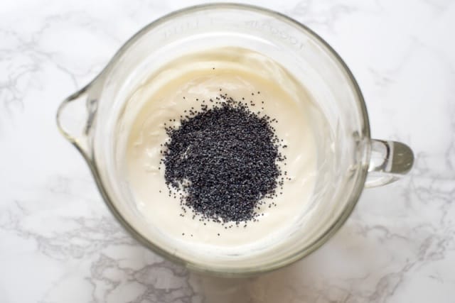 The poppy seed dressing is combined in a large glass measuring cup.