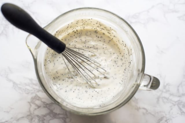 The poppy seed dressing is whisked together.