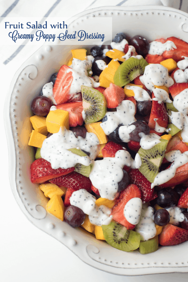 Fruit Salad with Creamy Poppy Seed Dressing in a white bowl with text overlay.