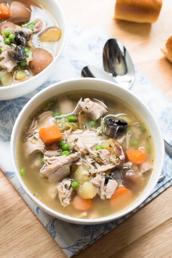 Slow Cooker Chicken and Spring Vegetable Stew in a white bowl.