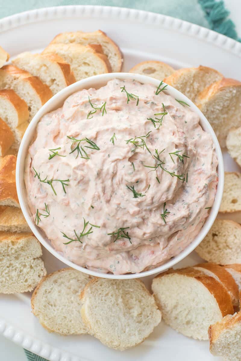 A platter with a bowl of the Smoked Salmon Dip and sliced baguette placed around it.