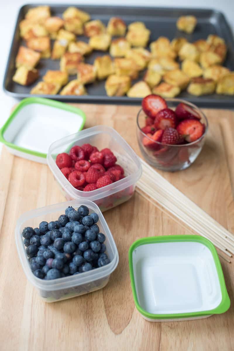 Two Freshworks containers filled with blueberries and rapberries.