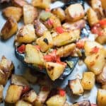 A close up of roasted breakfast potatoes on a baking sheet.