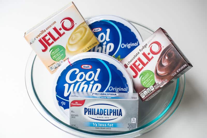 Cream cheese, Cool Whip, and pudding mix in a glass bowl.