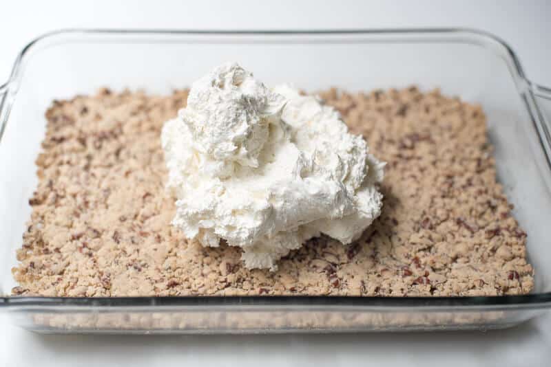 A creamy mixture is placed of a crust layer in a glass dish.