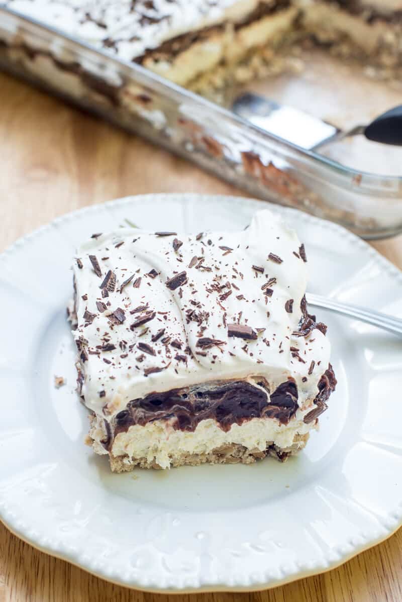 A slice of a creamy chocolate dessert on a white plate.
