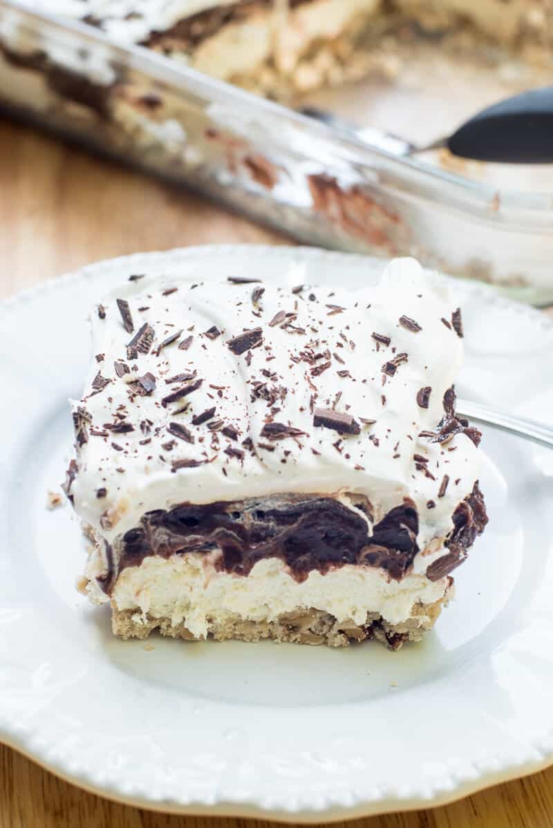 A close up of a slice of creamy dessert on a white plate.