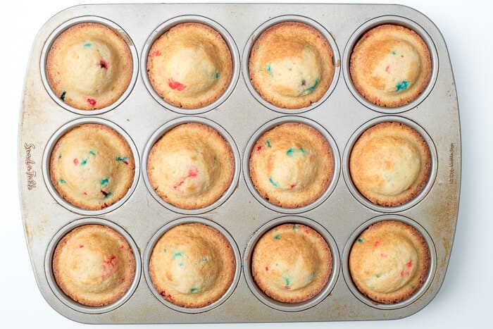 Funfetti cupcakes in a baking tin.