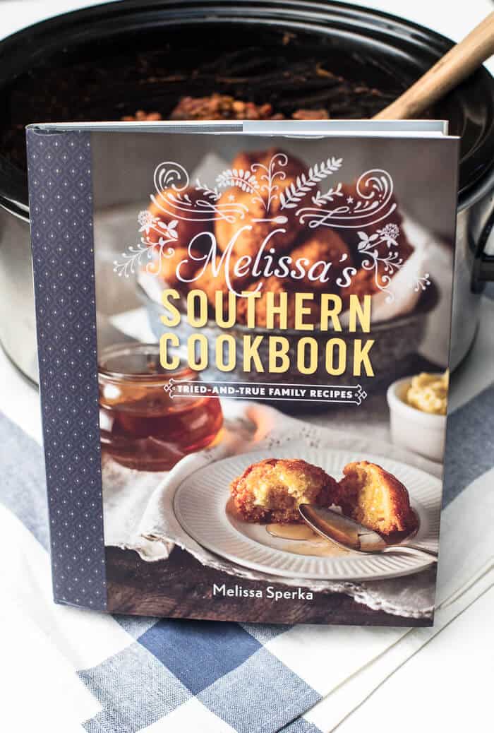 Melissa's Southern Cookbook leans against a slow cooker.