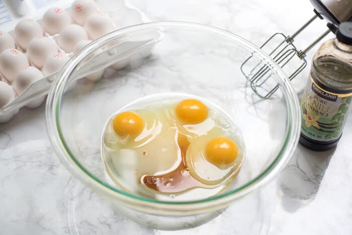 Oil, eggs, and vanilla in a glass mixing bowl.