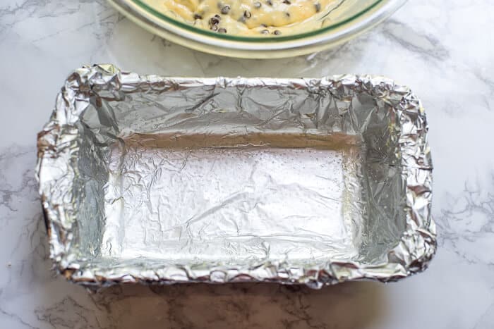 A loaf pan lined with foil that has been spray with non-stick cooking spray.
