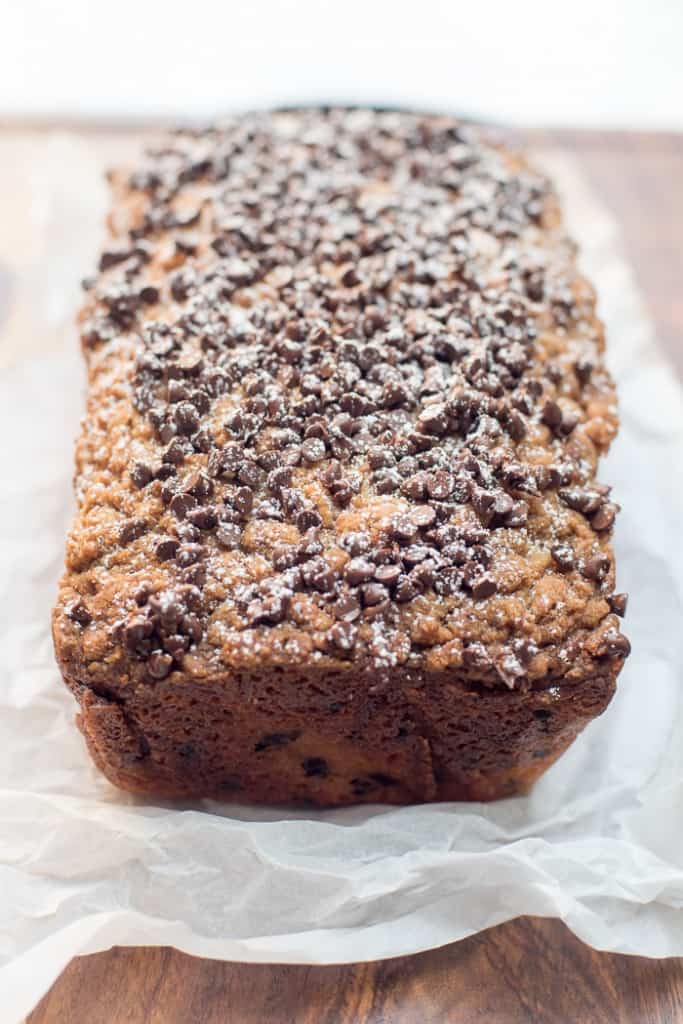 The chocolate chip crumb cake is sprinkled with powdered sugar.