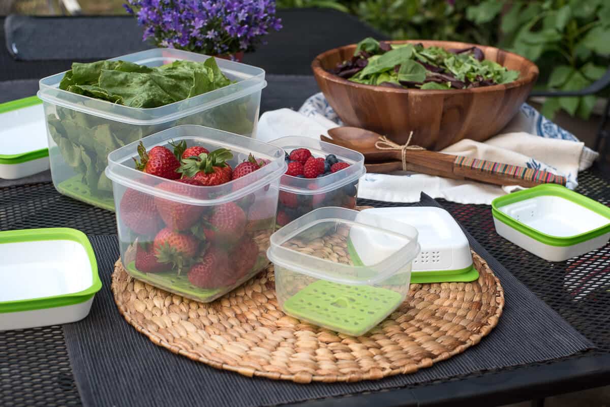 Rubbermaid containers filled with berries and spinach.