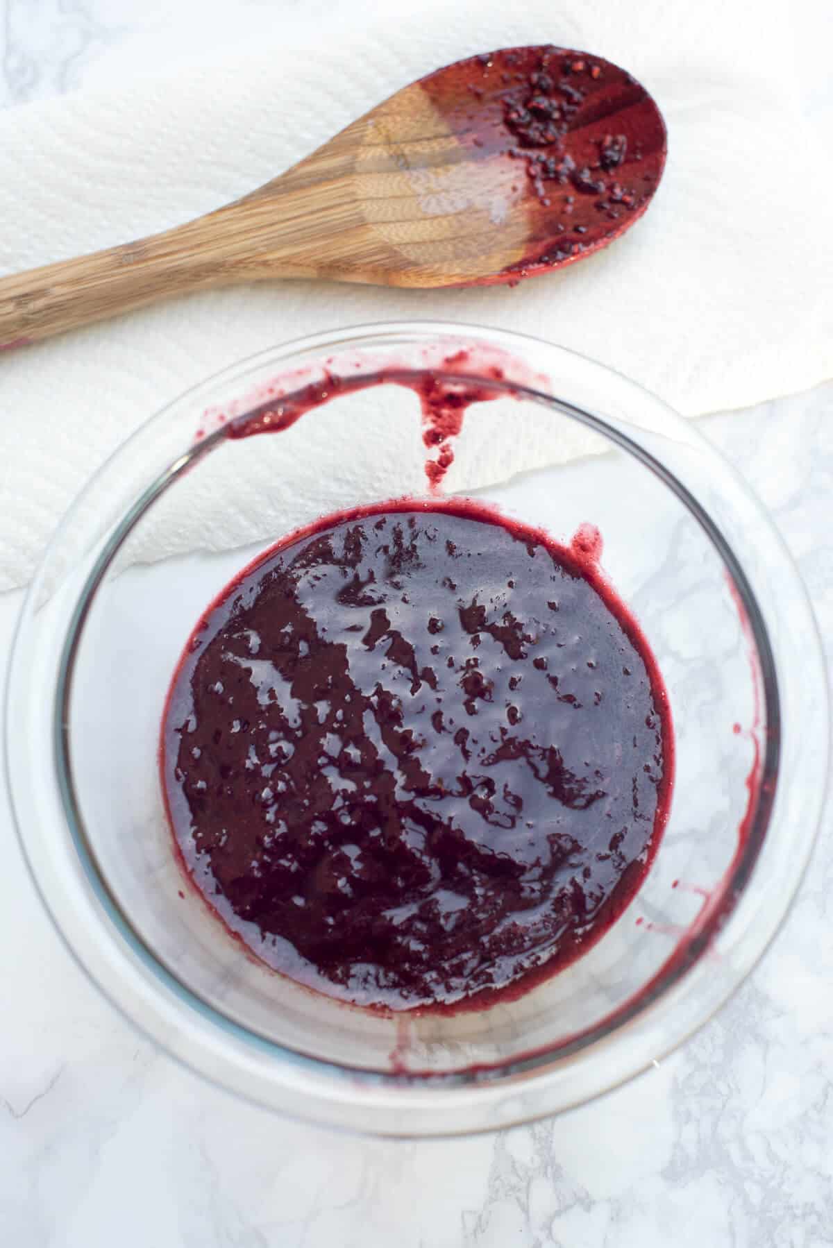 Silky berry puree in a glass bowl.