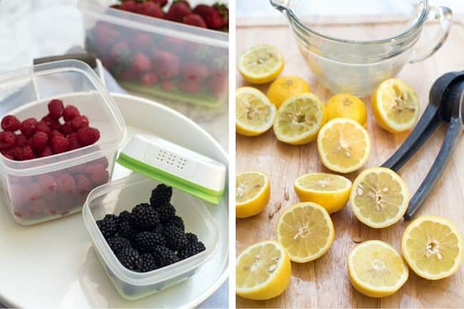 Berries in plastic Rubbermaid containers and halved lemons on a cutting board.