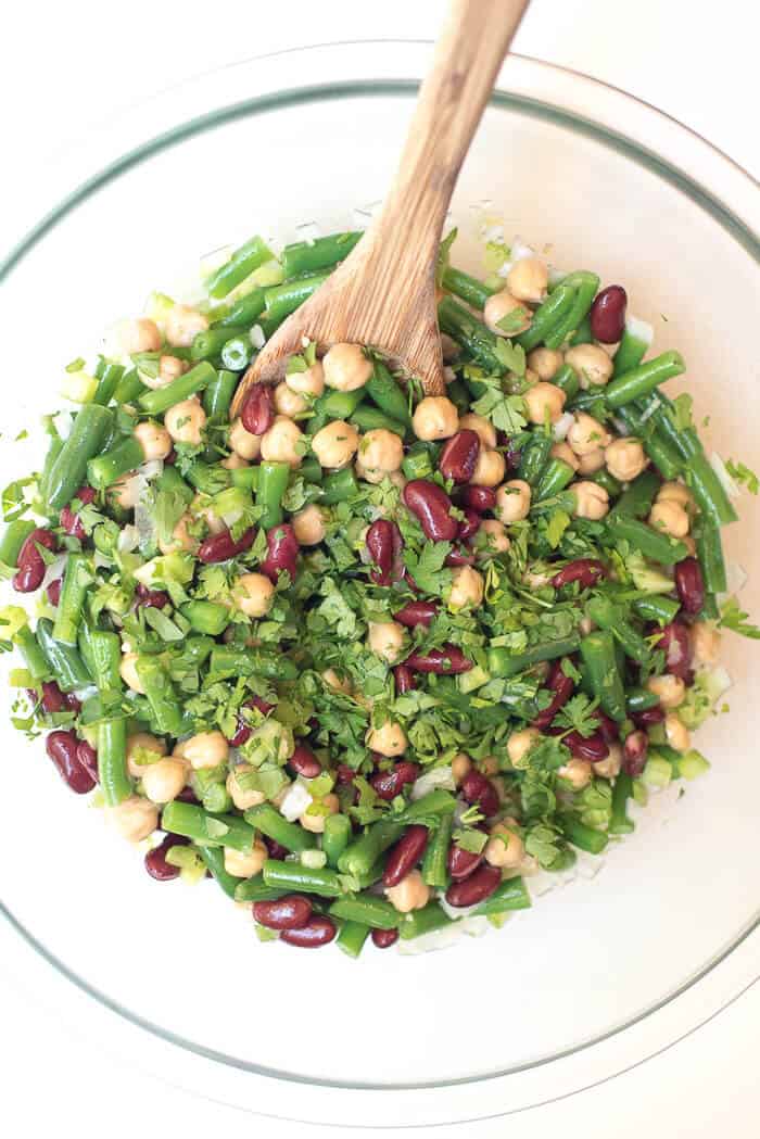 Fresh parsley is added to the bean salad.