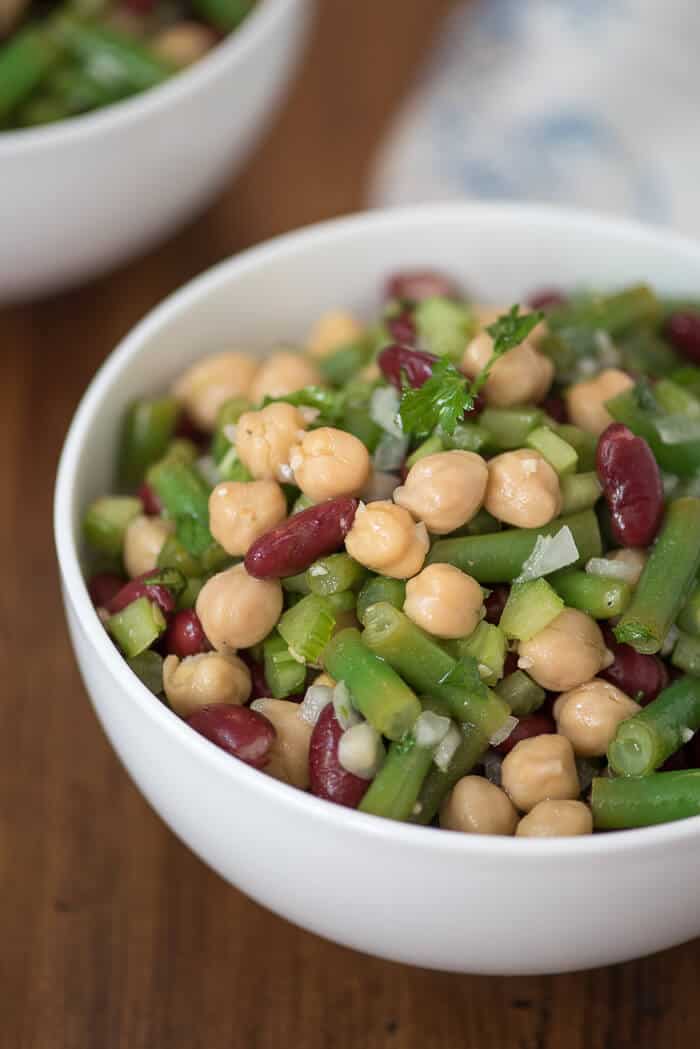 A close up image of the Three Bean Salad in a white bowl.