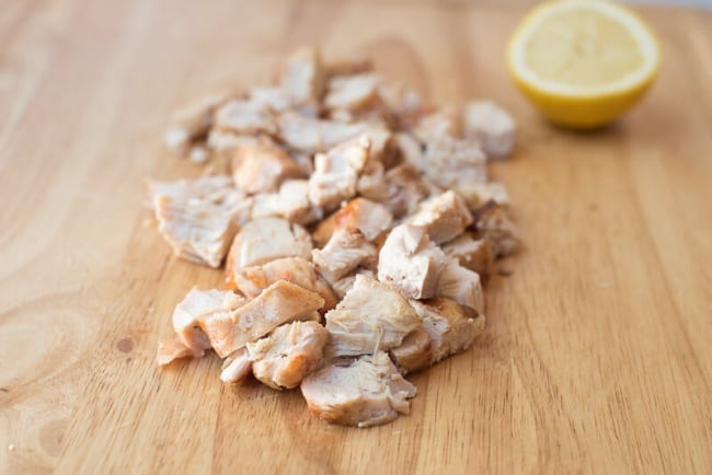 Chopped cooked chicken on a cutting board.