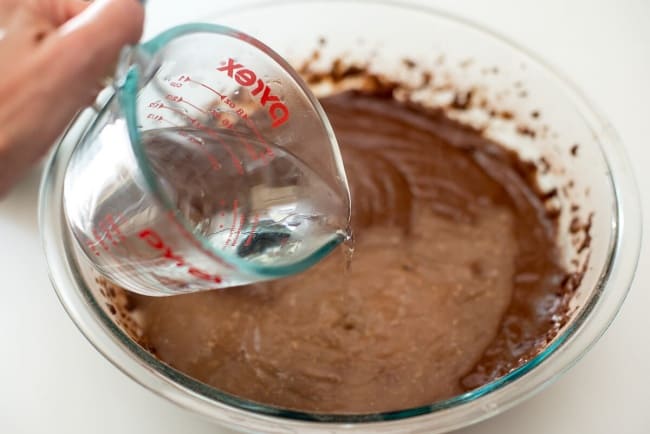 Hot water is poured into the cake batter.