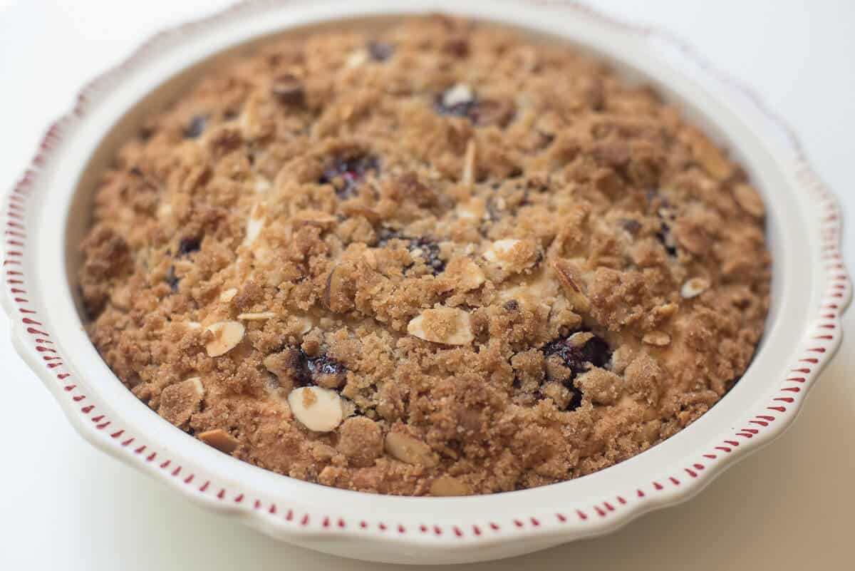 Fresh Cherry Crumb Cake in a white pie dish.