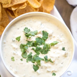 Easy Queso Verde in a white bowl topped with cilantro.