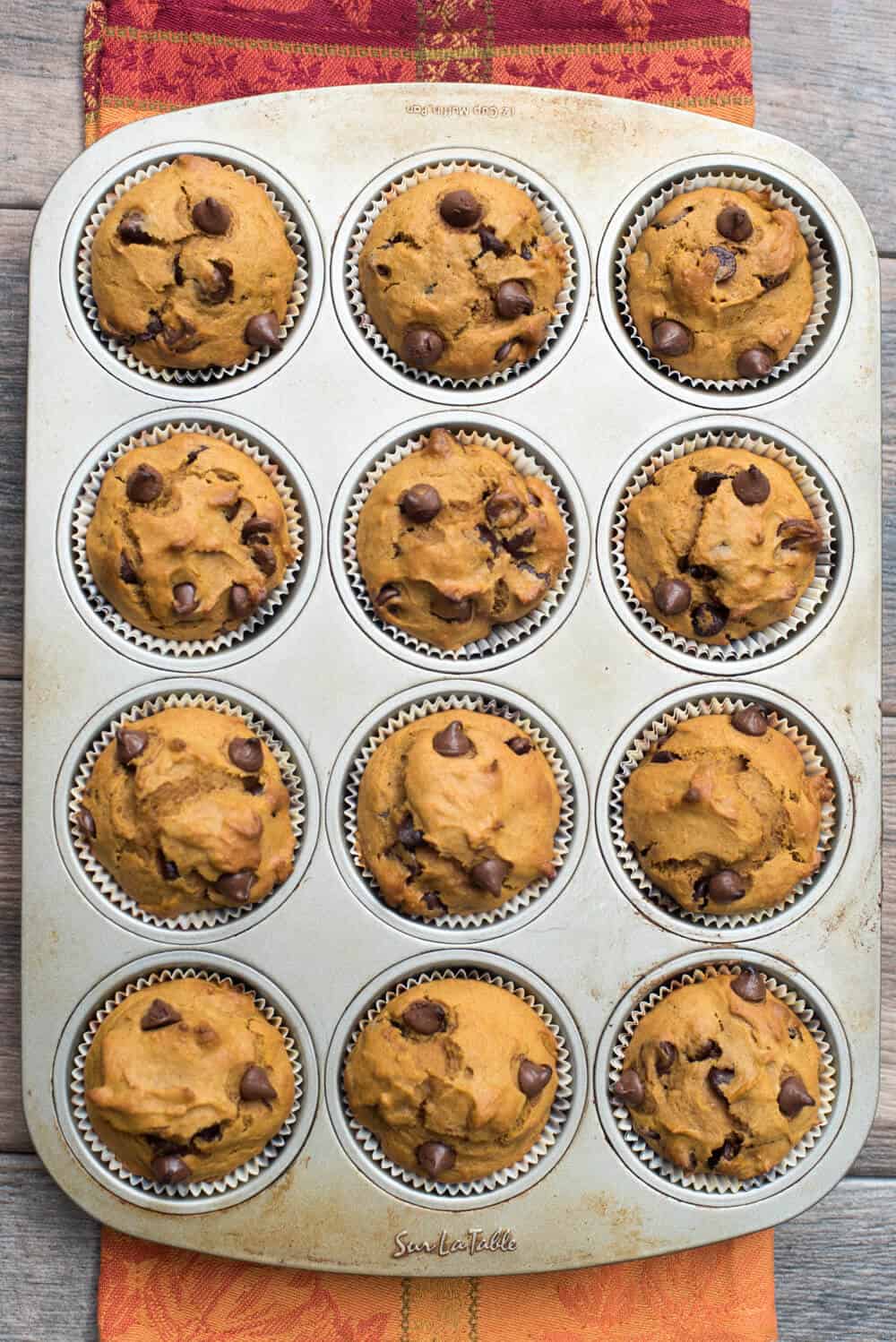 Pumpkin Chocolate Chip Muffins in a muffin tin shot from over the top.