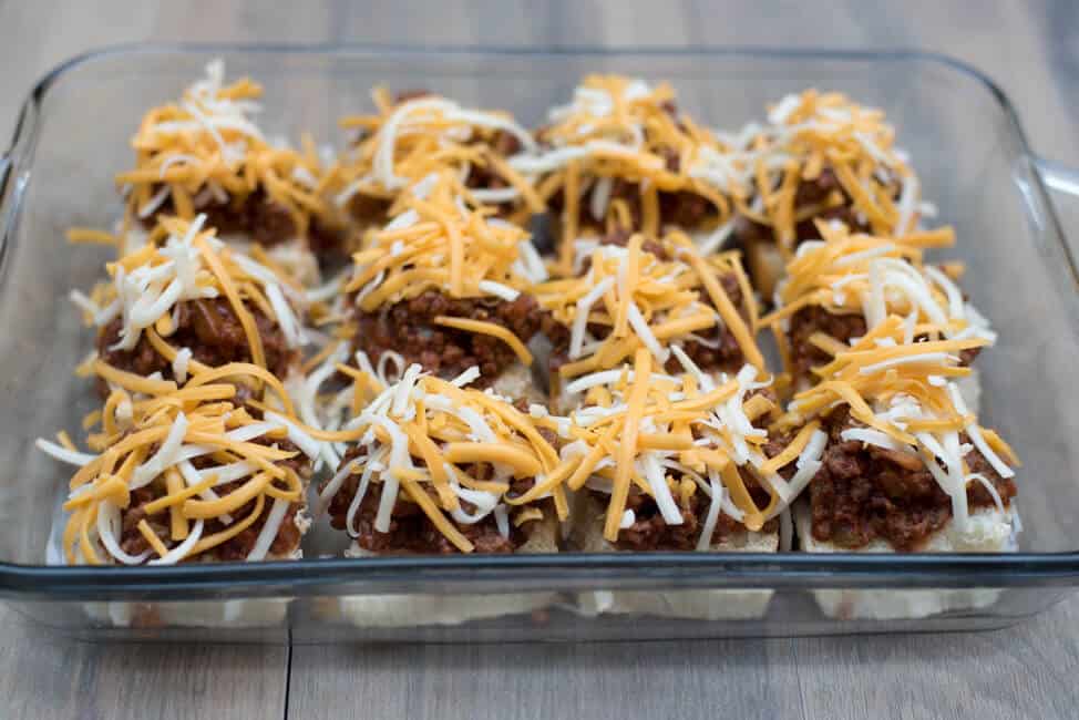 The sloppy joe mixture is topped with shredded cheese.