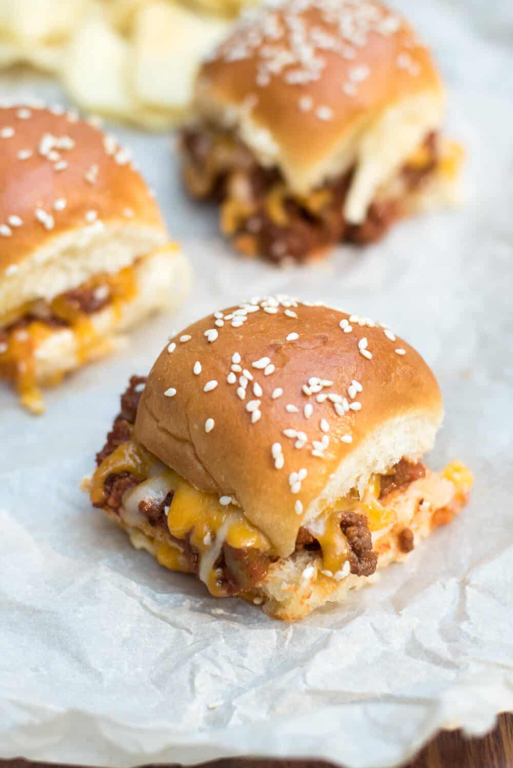 A close up of Sloppy Joe Sliders on white parchment paper.