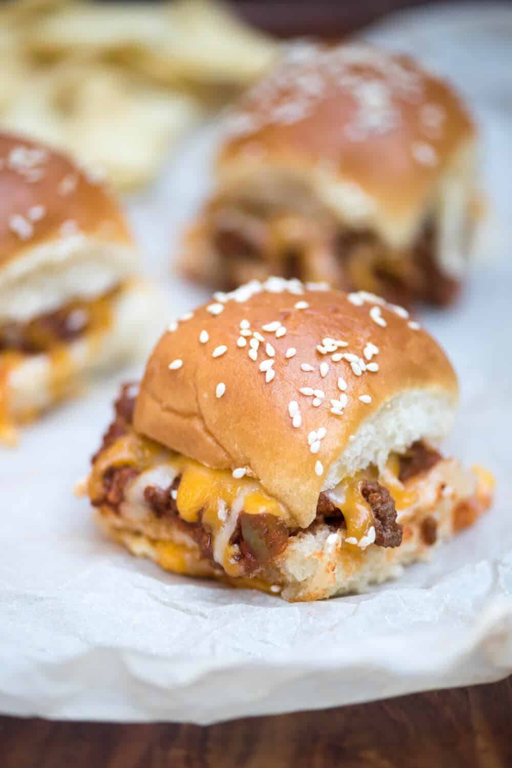 A close up of Sloppy Joe Sliders on white parchment paper