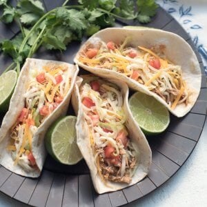 A brown tray filled with chicken tacos.